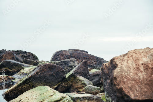 Close up photo of big boulders on the beach. Nature landscape.