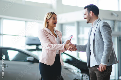 Portrait of happy customer buying new car