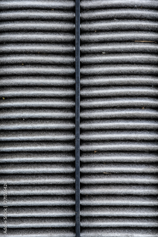 Obraz premium dirty texture of air filter for car, automotive spare part in plastic case