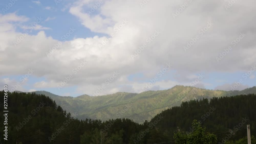 Beautiful view of mountain valley with fast rolling clouds drifting over mountains. Timelapse Beautiful view of mountain valley with fast rolling clouds drifting over mountains. Timelapse