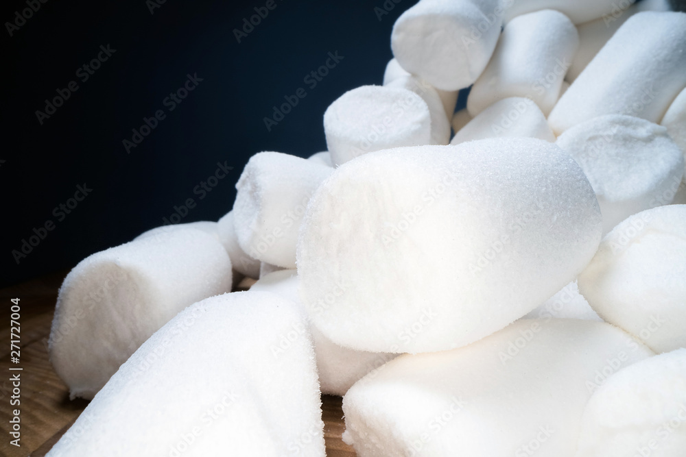 Obraz premium Pile of sweet and soft marshmallow. Yummy white sweets on dark background, fast food