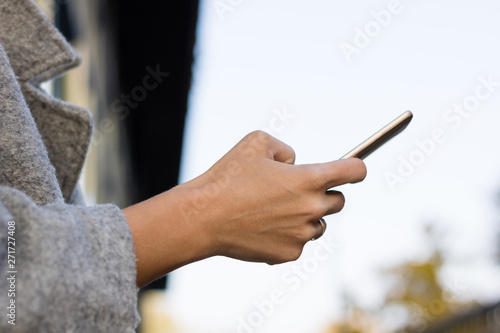 Close up of woman dialing on smart phone.
