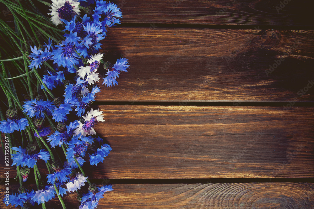 Fototapeta premium Blue Cornflower Herb on wooden surface