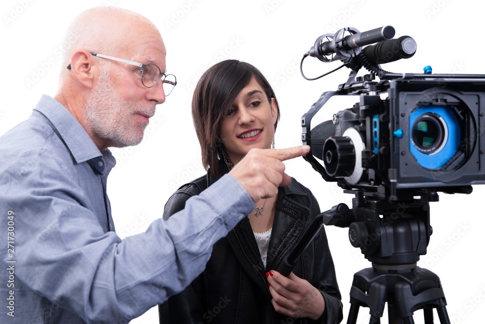 cameraman and a young woman with a movie camera DSLR on white