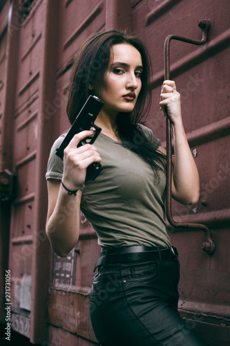 Powerful Woman Holding Gun Action Movie Style. Train adventure. Military girl with .
