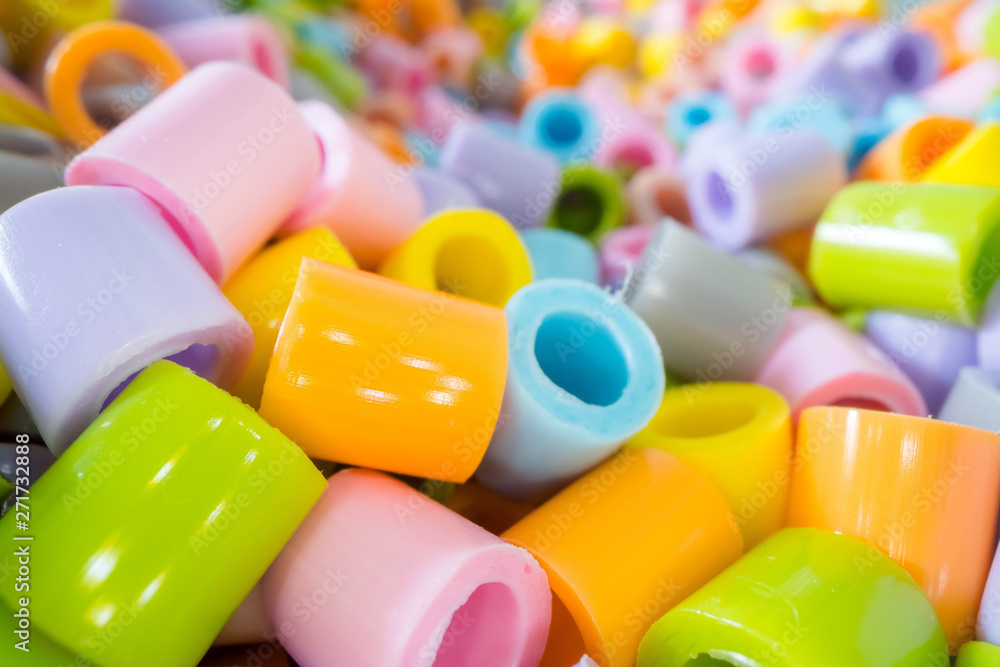Short plastic tube pieces stacked on top of each other. Plastic waste and recycling concept Short plastic tube pieces stacked on top of each other. Plastic waste and recycling concept