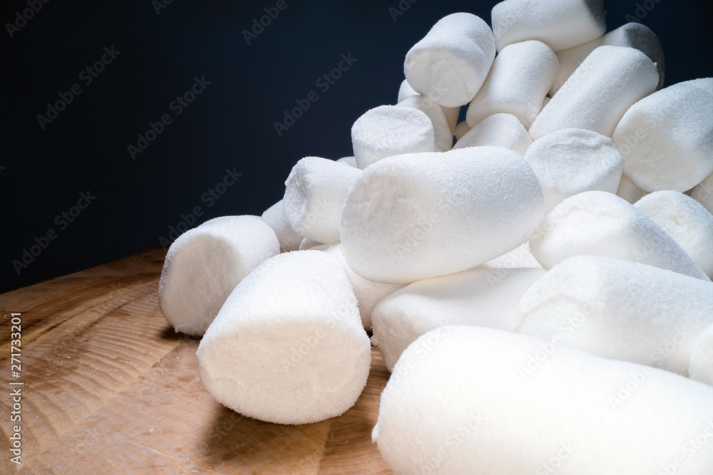 Pile of sweet and soft marshmallow. Yummy white sweets on dark background, fast food Pile of sweet and soft marshmallow. Yummy white sweets on dark background, fast food