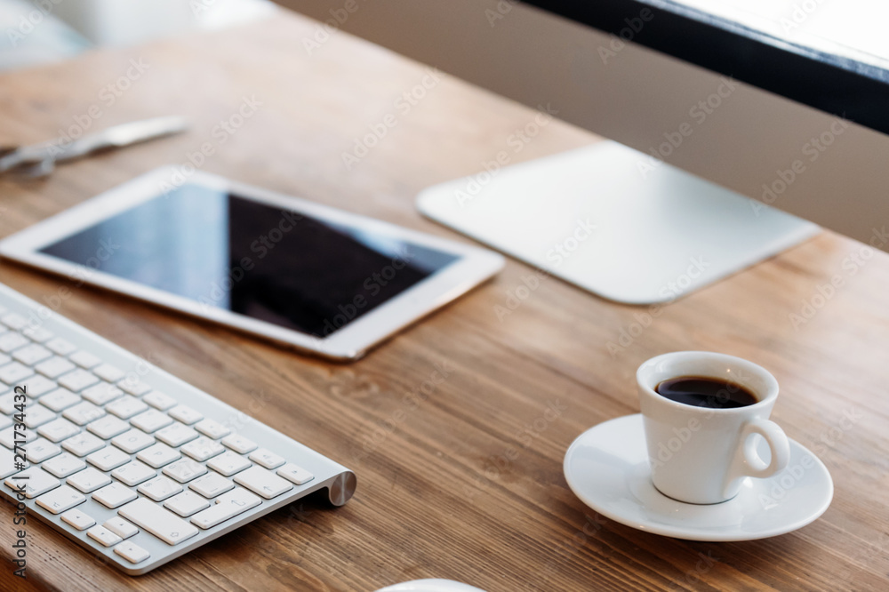 Office desk with computer, tablet and cup of coffee Office desk with computer, tablet and cup of coffee