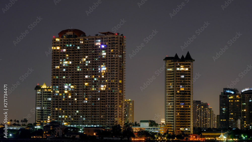 Business architecture, skyscrapers and light trails, Close shot of skyscrapers with lights, Night building. Business architecture, skyscrapers and light trails, Close shot of skyscrapers with lights, Night building.