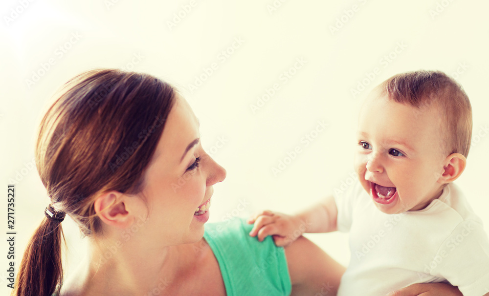 family, child and parenthood concept - happy smiling young mother with little baby at home family, child and parenthood concept - happy smiling young mother with little baby at home
