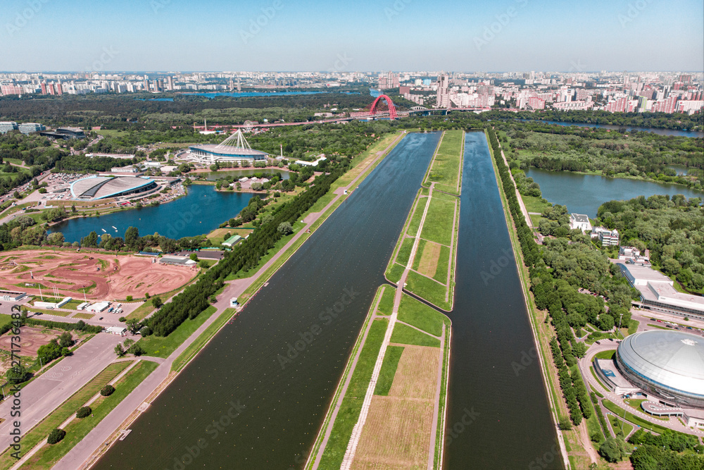 Rowing canal illuminated by bright sunshine. Panoramic view. Shooting from above, aerial filming. Olympic rowing canal in Moscow.