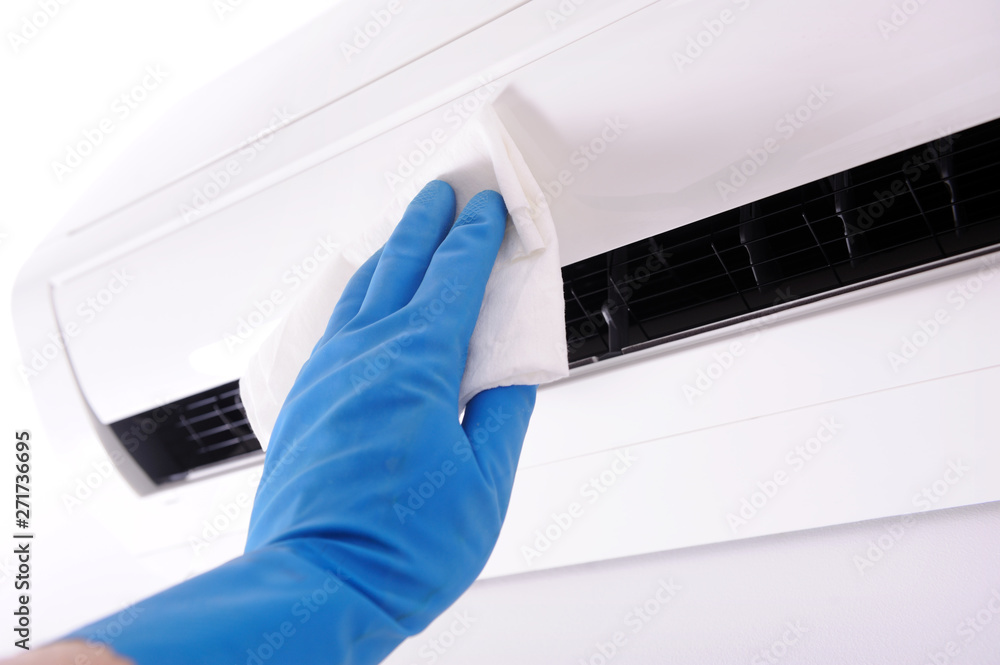 Specialist cleans and repairs the wall air conditioner.Disinfection in public places, the fight against the virus, coronavirus. Specialist cleans and repairs the wall air conditioner.Disinfection in public places, the fight against the virus, coronavirus.