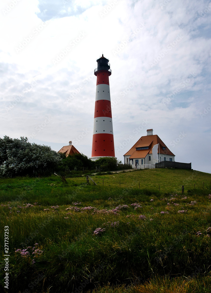 Westerhever lighthouse from a distance over green meadows Westerhever lighthouse from a distance over green meadows