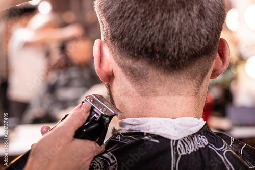 Close up of a male student having a haircut with hair clippers