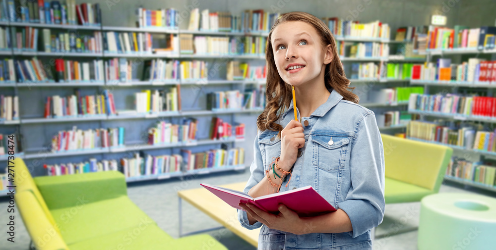 education, school, inspiration and people concept - young woman or teenage student girl in denim jacket with diary or notebook and pencil thinking over reading room of library background education, school, inspiration and people concept - young woman or teenage student girl in denim jacket with diary or notebook and pencil thinking over reading room of library background