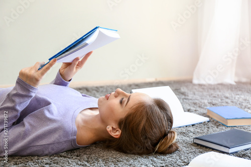 Female student reading book...