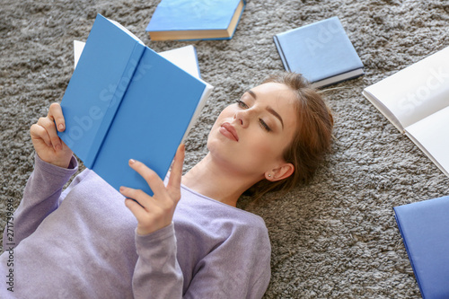 Female student reading book...
