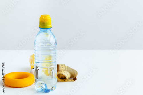 Water bottle and fitness equipment isolated on white
