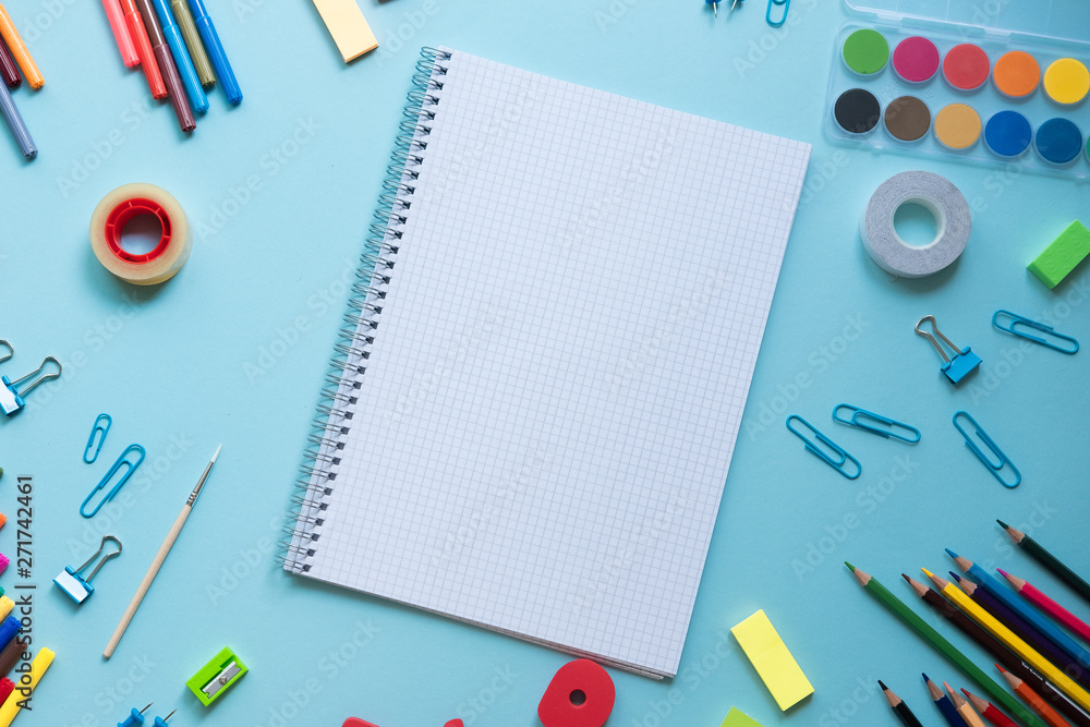 School supplies lay on blue background, back to school concept, copy space School supplies lay on blue background, back to school concept, copy space