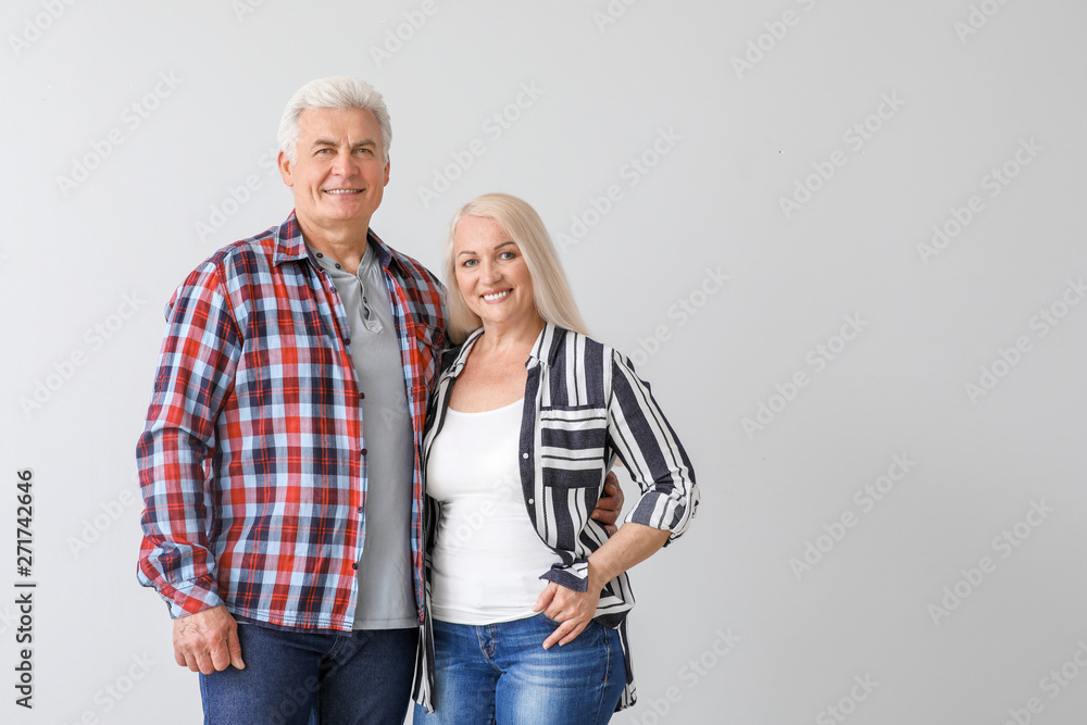 Portrait of happy mature couple on light background Portrait of happy mature couple on light background