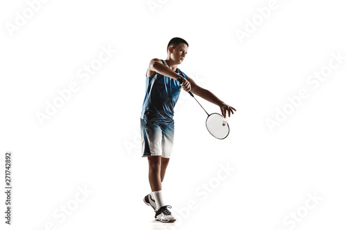 Little boy playing badminton isolated on white studio background. Young male model in sportwear and sneakers with the racket in action, motion in game. Concept of sport, movement, healthy lifestyle. © master1305