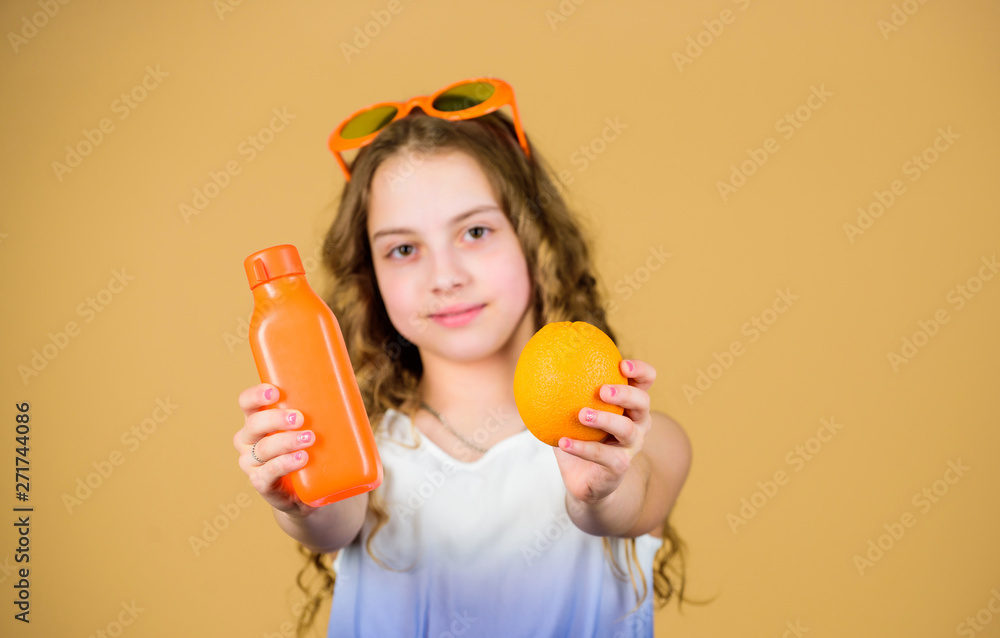 Health in her hands. Natural vitamin source. happy girl drink fresh orange juice. summer vacation. little girl in glasses. Vitamin nutrition. refreshing vitamin juice. Health care. vitamin diet Health in her hands. Natural vitamin source. happy girl drink fresh orange juice. summer vacation. little girl in glasses. Vitamin nutrition. refreshing vitamin juice. Health care. vitamin diet
