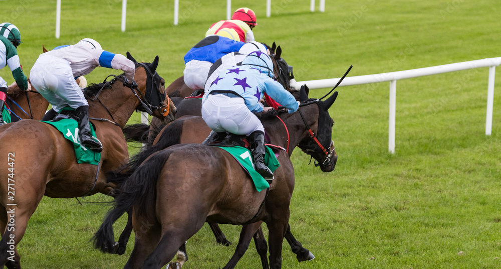 Close up on group of jockeys and race horses galloping towards the finish line Close up on group of jockeys and race horses galloping towards the finish line