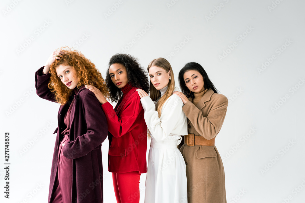 beautiful blonde and redhead women standing with african american girls on white