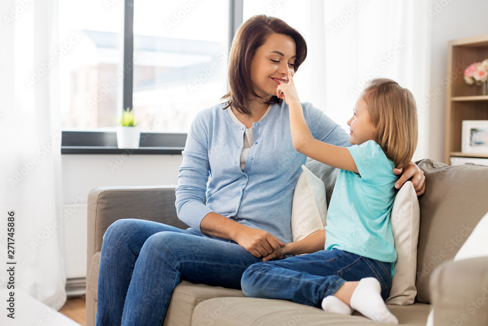 family, generation and people concept - happy smiling mother and daughter looking at each other at home family, generation and people concept - happy smiling mother and daughter looking at each other at home