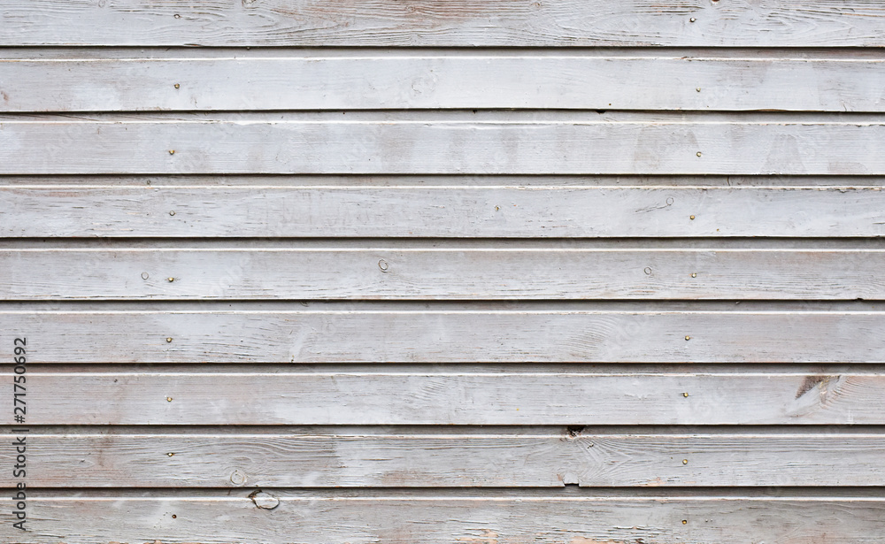 Unique texture painted with gray oil paint wooden planks of the old building with ranks of hammered nails Unique texture painted with gray oil paint wooden planks of the old building with ranks of hammered nails