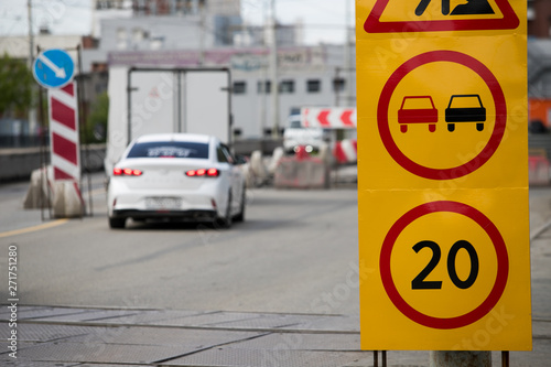 Damaged asphalt road. Repair of engineering road highways. Bad road. Detour sign on the road especially dangerous pits. Dangerous road. Emergency road. Wounds on the road