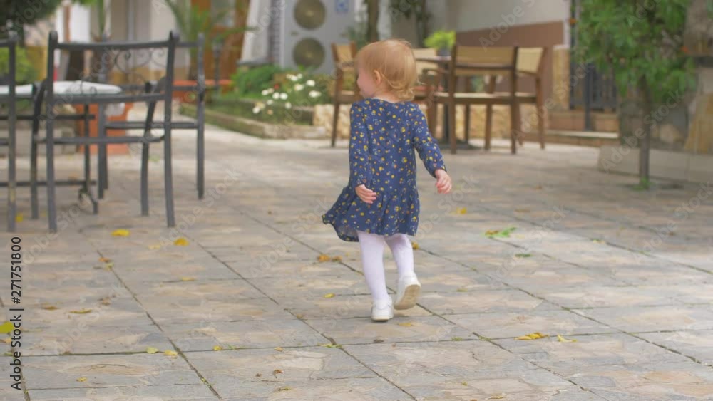 Little girls with a blue dress are walking around nature Little girls with a blue dress are walking around nature