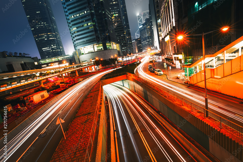 Street traffic at twilight sunset in Hong Kong. Office skyscraper buildings and with blurred car light trails. Hong Kong, Special administrative region in China. Toned Street traffic at twilight sunset in Hong Kong. Office skyscraper buildings and with blurred car light trails. Hong Kong, Special administrative region in China. Toned