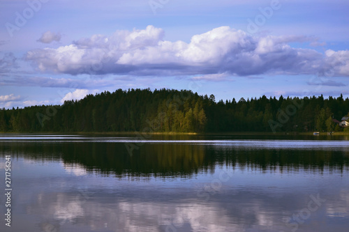 Landscape with lake, blue sky, beautiful clouds and reflection in the water