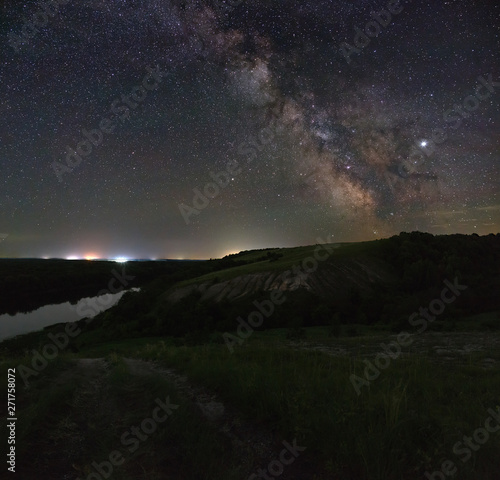 View of the Milky Way over the river. Bright stars of the night sky. Astrophotography with a long exposure.