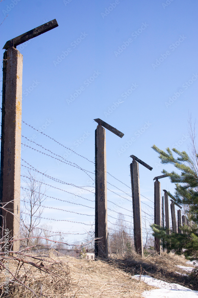 Metal fence wire, War and sky in the background spring Metal fence wire, War and sky in the background spring