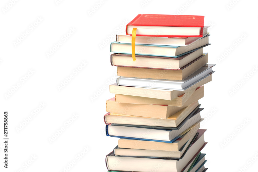 High pile of different books isolated on a white background. Red book with yellow bookmark on top of the pile High pile of different books isolated on a white background. Red book with yellow bookmark on top of the pile