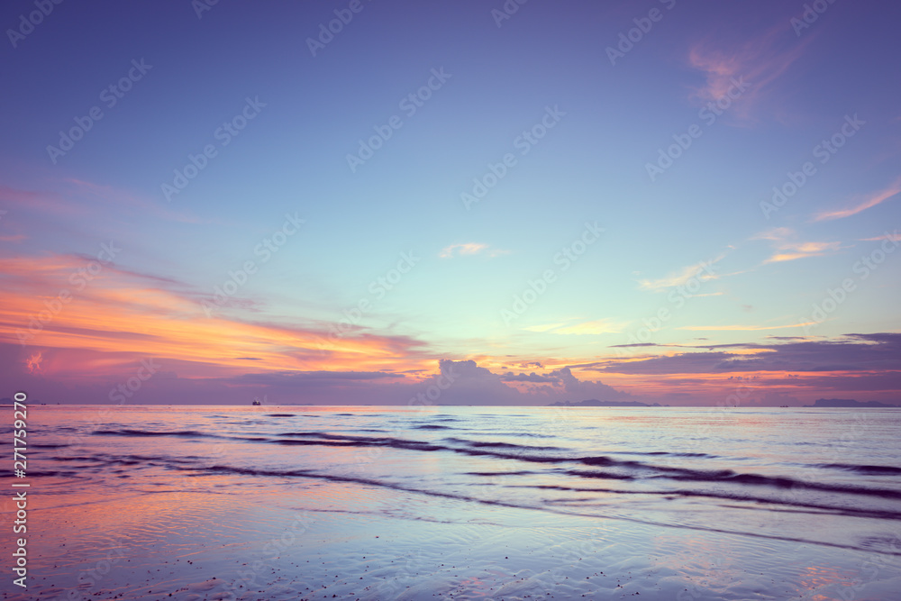 Beautiful tropical pink blue sea  sunset and yellow clouds baclground