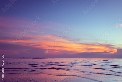 Beautiful tropical pink blue sea sunset and yellow clouds baclground