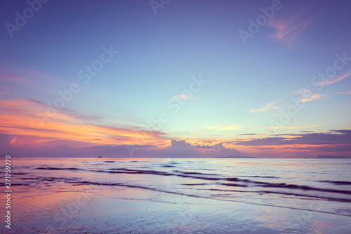 Beautiful tropical pink blue sea sunset and yellow clouds baclground