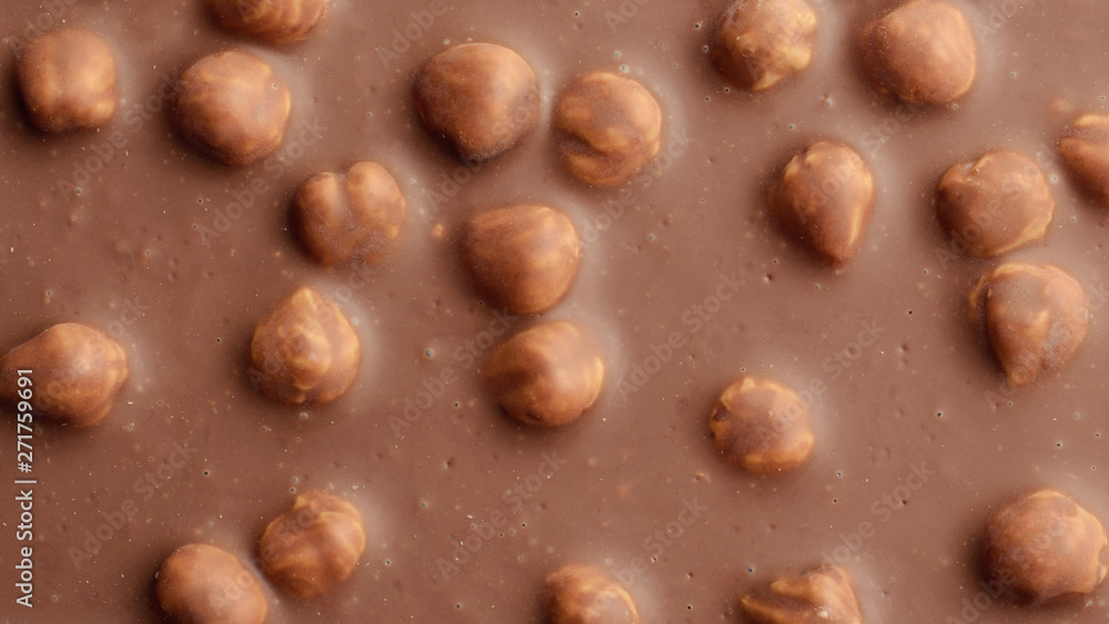 Chocolate background with hazelnuts Chocolate background with hazelnuts