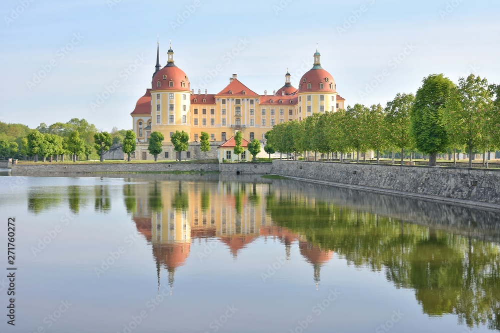 Exquisite medieval castle Moritzburg built in the Baroque style in the 16th century, Germany, Saxony. Traveling concept background. The magnificent castle Moritzburg surrounded by a lake and a beautif
