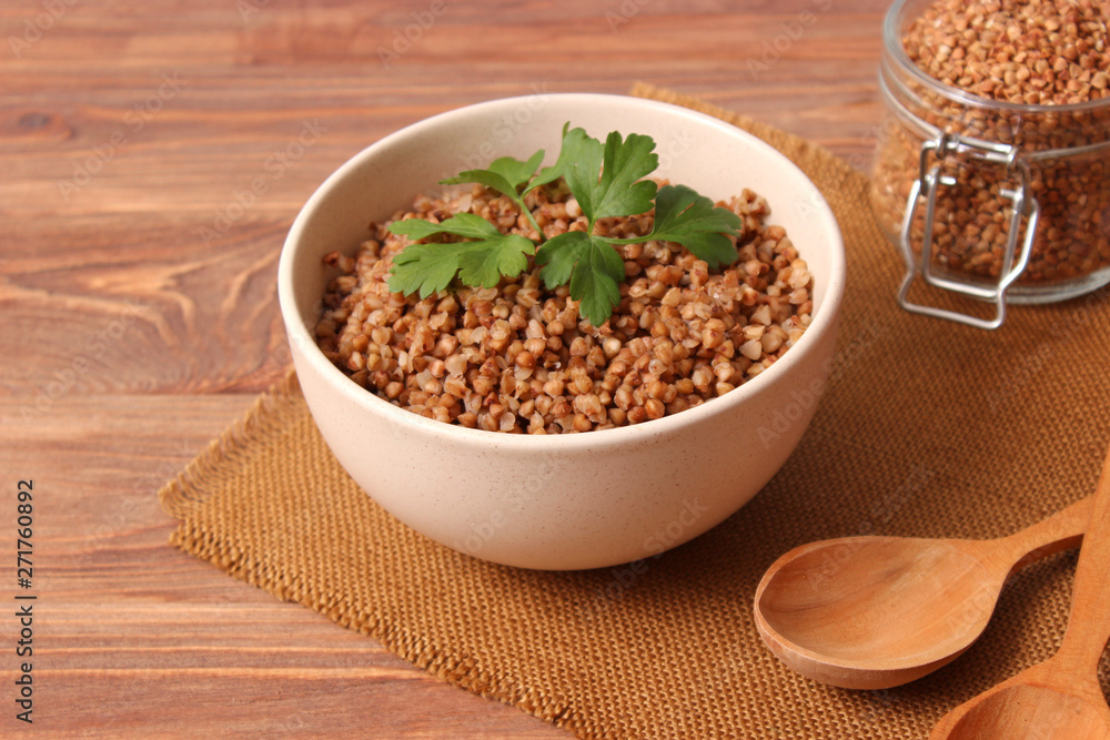 boiled buckwheat in a plate on the table. boiled buckwheat in a plate on the table.