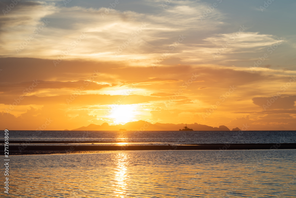 Beautiful beach sunset with blue sea and golden light sky cloud background Beautiful beach sunset with blue sea and golden light sky cloud background