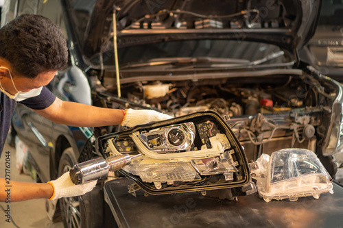Tableau sur toile Car mechanic, doing cleaning, The headlight of the car, installation and turning headlight of modern automobile and car projector lens