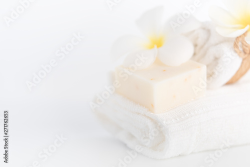 White towels,organic soap and Plumeria flower over white background,spa concept