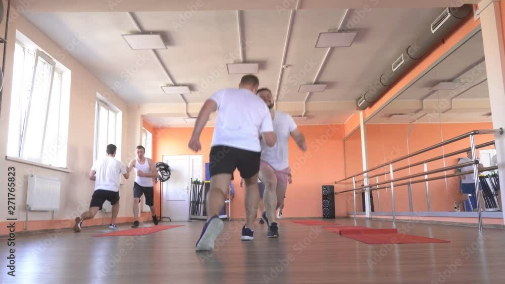 Handsome caucasian men friends train in a modern gym in a group steam training for developing endurance and burning excess weight, sportswear Handsome caucasian men friends train in a modern gym in a group steam training for developing endurance and burning excess weight, sportswear