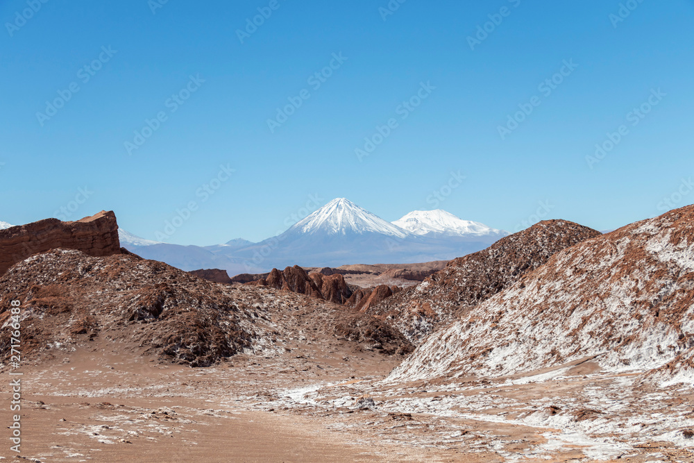Moonlike landscape of dunes, rugged mountains and rock formations of Valle de la Luna (Moon valley), Atacama desert, Chile
