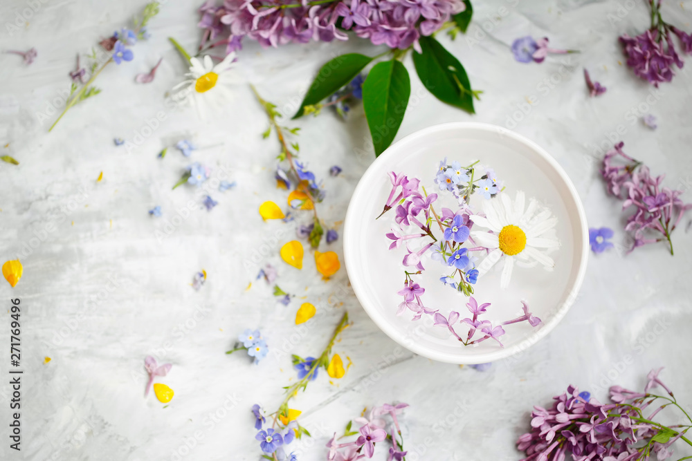 Spa still life with flowers, top view of beauty spa treatments with floral extracts and oils, aromatherapy spa setting Spa still life with flowers, top view of beauty spa treatments with floral extracts and oils, aromatherapy spa setting