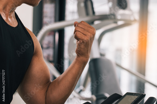 The bodybuilder shows his arm muscles and sweat to see strength at fitness. Helps the muscles of the heart to have good health and makes the blood pumping more effective.